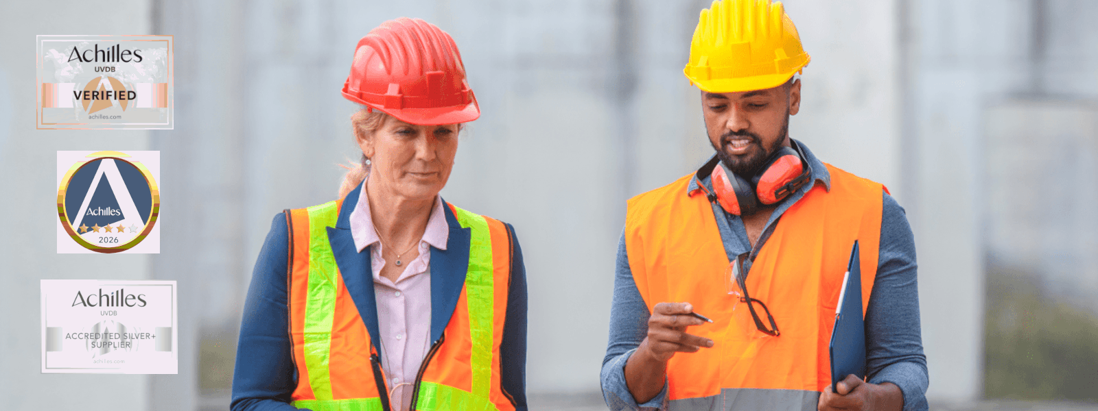 Man and woman in hard hats and high vis vests